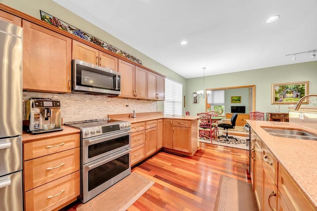 20015 Founders Way, Olympia Fields, IL 60461 - kitchen featuring stainless steel appliances, light wood-style flooring, decorative backsplash, a peninsula, and light brown cabinetry
