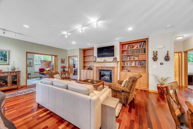 20015 Founders Way, Olympia Fields, IL 60461 - living area with track lighting, light wood-type flooring, a brick fireplace, recessed lighting, and built in shelves