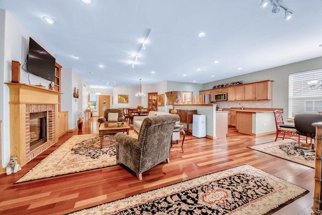 20015 Founders Way, Olympia Fields, IL 60461 - living area featuring track lighting, light wood-style flooring, a fireplace, a chandelier, and recessed lighting