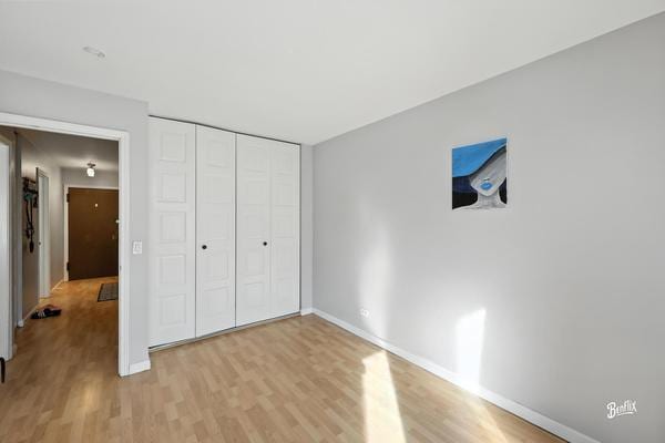 1425 Sandpebble Dr Unit 340, Wheeling, IL 60090 - unfurnished bedroom with light wood-style flooring and a closet
