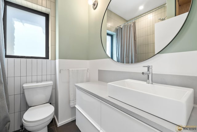 3632 S Winchester Ave, Chicago, IL 60609 - bathroom with vanity, a shower with shower curtain, and tile walls