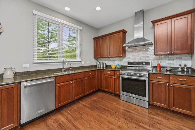 10 Park Ave, River Forest, IL 60305 - kitchen featuring appliances with stainless steel finishes, wall chimney range hood, dark wood finished floors, tasteful backsplash, and recessed lighting