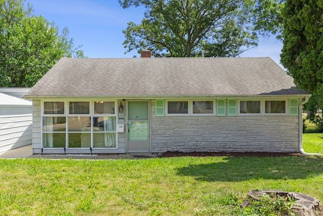 123 Tilton Park Dr, Dekalb, IL 60115 - view of front of house with a chimney, stone siding, and a front yard