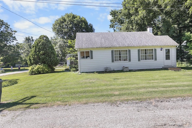 162 Grant St, Seneca, IL 61360 - view of front facade with a chimney, a front yard, and a shingled roof