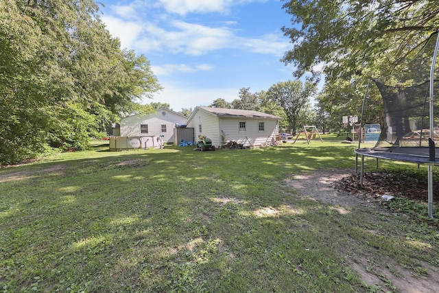 162 Grant St, Seneca, IL 61360 - view of green lawn featuring a trampoline, a playground, and a shed