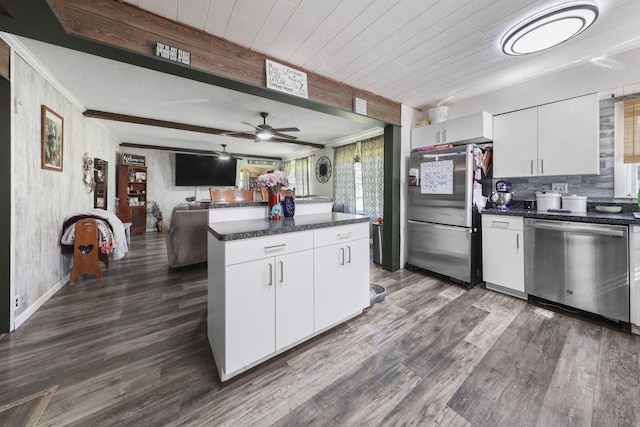 162 Grant St, Seneca, IL 61360 - kitchen with appliances with stainless steel finishes, a center island, dark wood-type flooring, decorative backsplash, and ornamental molding