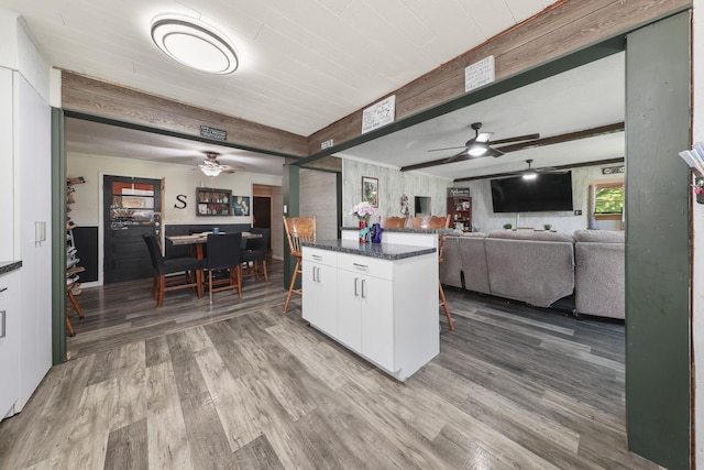 162 Grant St, Seneca, IL 61360 - kitchen featuring a ceiling fan, wood finished floors, white cabinetry, beam ceiling, and open floor plan