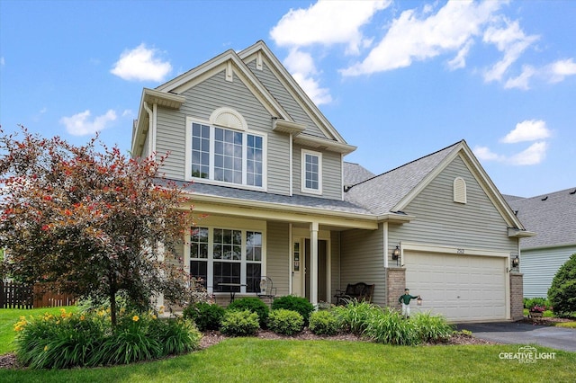7512 Prairieside Dr, Plainfield, IL 60586 - traditional-style home featuring asphalt driveway, covered porch, a garage, and brick siding