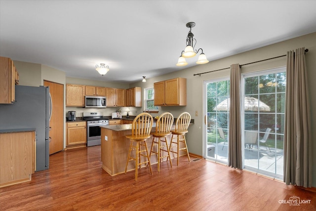 7512 Prairieside Dr, Plainfield, IL 60586 - kitchen featuring appliances with stainless steel finishes, healthy amount of natural light, and dark wood-style floors