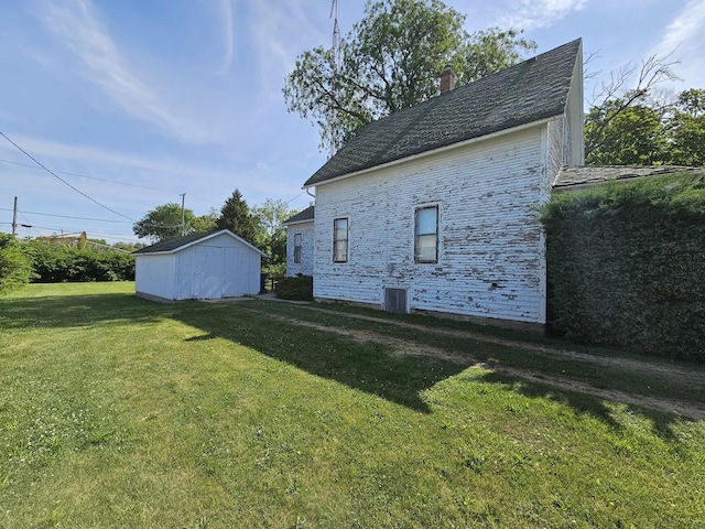 216 E Delaware St, Dwight, IL 60420 - view of side of home with a lawn, a chimney, and an outdoor structure
