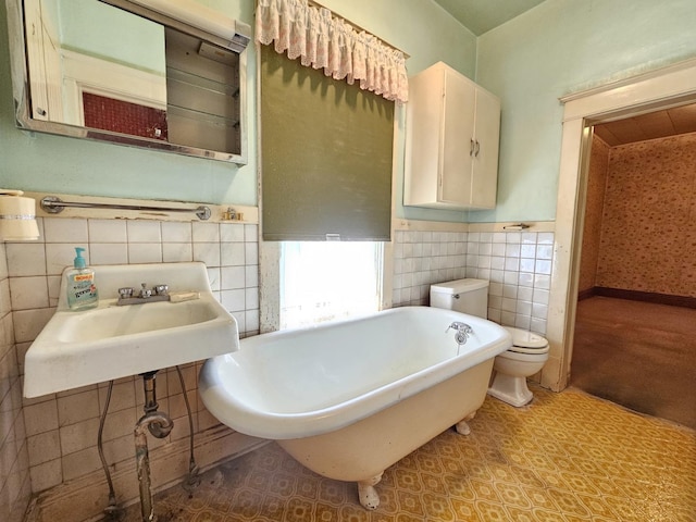 216 E Delaware St, Dwight, IL 60420 - full bath with tile walls, a freestanding bath, and wainscoting
