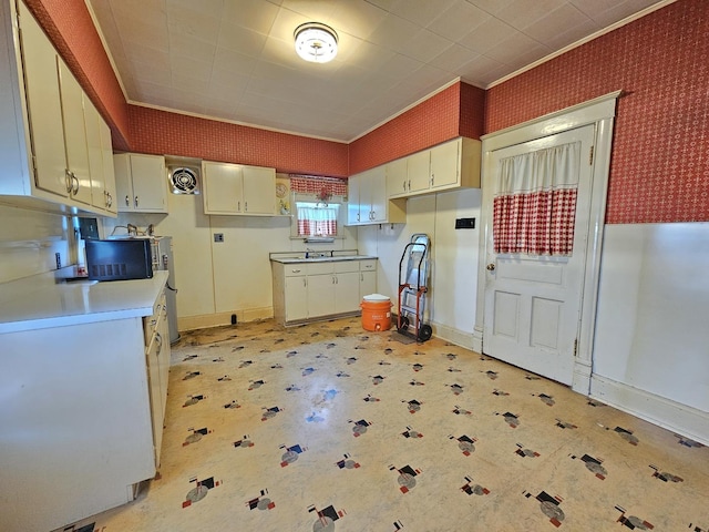 216 E Delaware St, Dwight, IL 60420 - kitchen featuring ornamental molding, light flooring, and wallpapered walls
