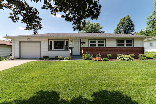 1001 Sheridan Rd, Normal, IL 61761 - ranch-style home with brick siding, concrete driveway, a garage, and a front lawn