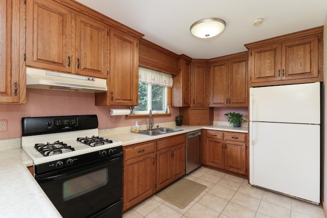 1001 Sheridan Rd, Normal, IL 61761 - kitchen with freestanding refrigerator, gas stove, under cabinet range hood, stainless steel dishwasher, and brown cabinetry
