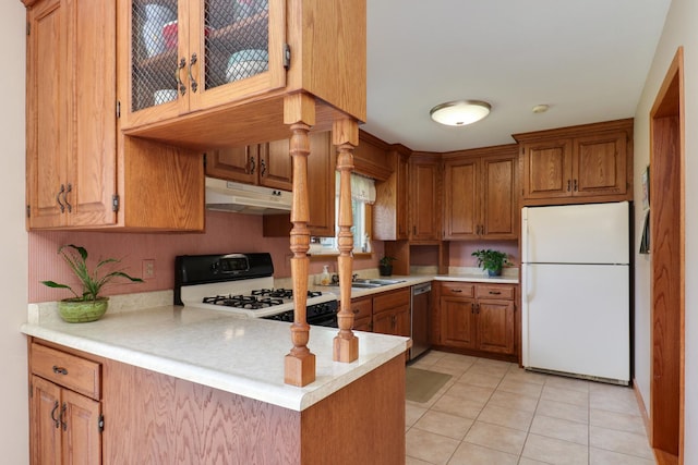 1001 Sheridan Rd, Normal, IL 61761 - kitchen featuring white appliances, under cabinet range hood, light countertops, and brown cabinets