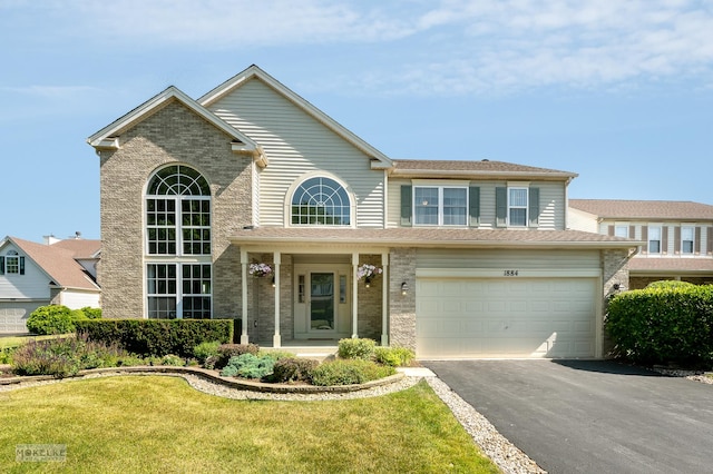 1884 Shore Line Ct, Romeoville, IL 60446 - traditional-style home featuring brick siding, driveway, a front yard, and a garage