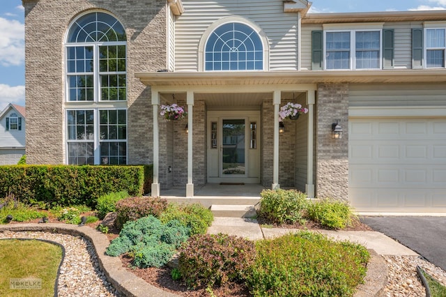 1884 Shore Line Ct, Romeoville, IL 60446 - property entrance with brick siding, a porch, and an attached garage