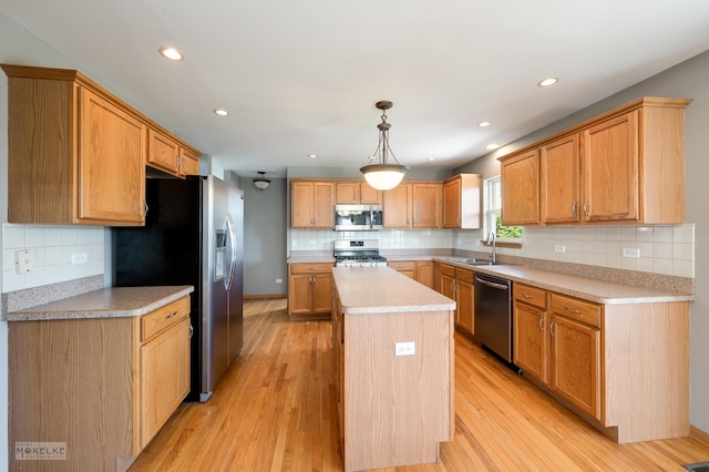 1884 Shore Line Ct, Romeoville, IL 60446 - kitchen featuring stainless steel appliances, a kitchen island, tasteful backsplash, light countertops, and light wood-style floors