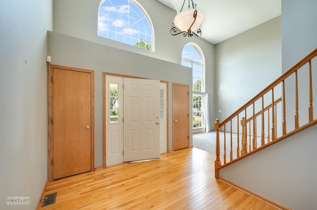 1884 Shore Line Ct, Romeoville, IL 60446 - entryway with a towering ceiling, wood-type flooring, and stairway