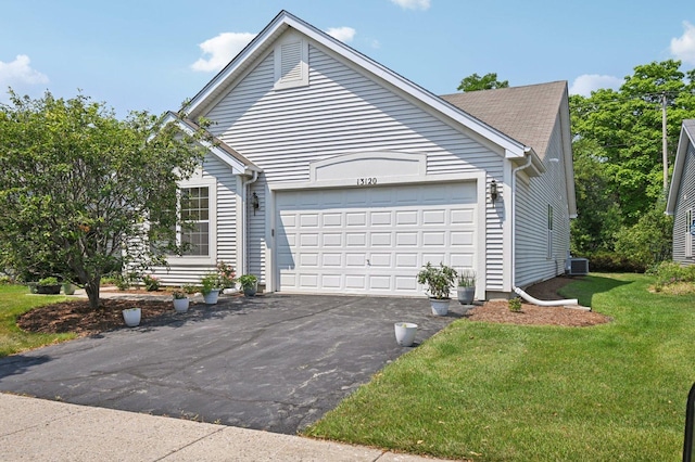13120 Birmingham Ct, Beach Park, IL 60083 - view of side of property featuring asphalt driveway, an attached garage, and a yard