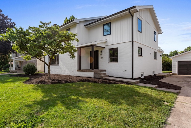 1205 Broadmoor Dr, Champaign, IL 61821 - modern farmhouse style home with brick siding, a front lawn, a garage, concrete driveway, and an outdoor structure