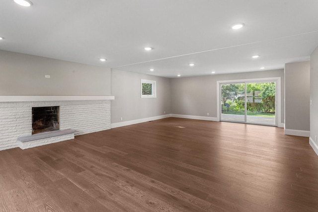1205 Broadmoor Dr, Champaign, IL 61821 - unfurnished living room featuring wood finished floors, a brick fireplace, and recessed lighting