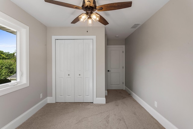 1205 Broadmoor Dr, Champaign, IL 61821 - unfurnished bedroom with carpet, a closet, and a ceiling fan