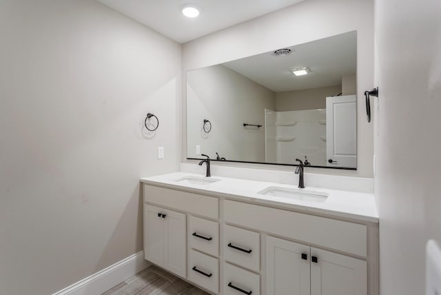 1205 Broadmoor Dr, Champaign, IL 61821 - full bathroom with double vanity, wood finished floors, and a shower
