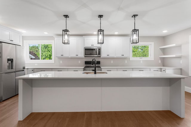 1205 Broadmoor Dr, Champaign, IL 61821 - kitchen featuring appliances with stainless steel finishes, recessed lighting, an island with sink, light countertops, and healthy amount of natural light