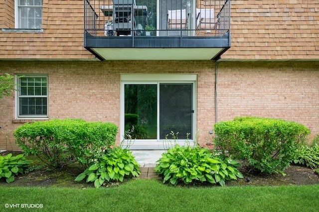 1220 Park Ave W Unit 110, Highland Park, IL 60035 - view of home's exterior with a balcony and brick siding