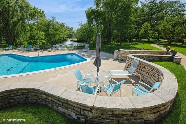 1220 Park Ave W Unit 110, Highland Park, IL 60035 - community pool featuring a patio area, view of scattered trees, and a lawn