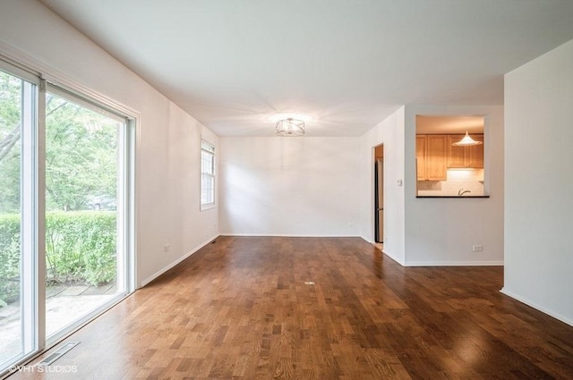 1220 Park Ave W Unit 110, Highland Park, IL 60035 - spare room featuring wood finished floors and a chandelier