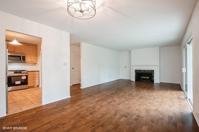 1220 Park Ave W Unit 110, Highland Park, IL 60035 - unfurnished living room featuring light wood-style floors and a fireplace