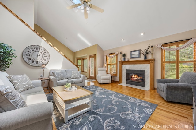 2436 Haider Ave, Naperville, IL 60564 - living area with wood finished floors, plenty of natural light, a tile fireplace, a ceiling fan, and high vaulted ceiling