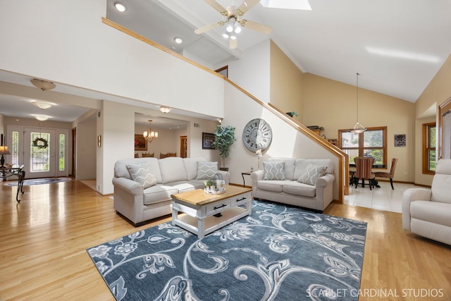 2436 Haider Ave, Naperville, IL 60564 - living room featuring a chandelier, high vaulted ceiling, wood finished floors, ceiling fan, and stairs