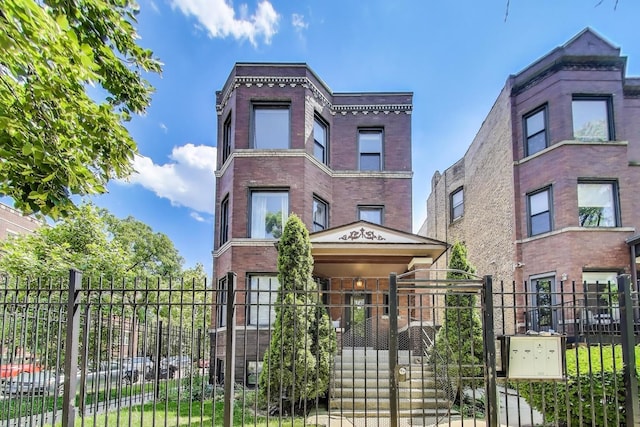 3253 W Palmer St Unit 301, Chicago, IL 60647 - view of front of property with brick siding, a gate, and a fenced front yard