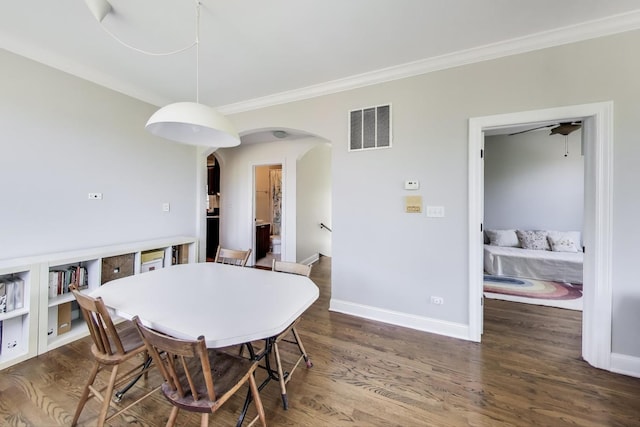 3253 W Palmer St Unit 301, Chicago, IL 60647 - dining room featuring arched walkways, crown molding, and wood finished floors