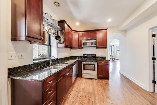 3253 W Palmer St Unit 301, Chicago, IL 60647 - kitchen featuring stainless steel appliances, arched walkways, healthy amount of natural light, light wood-style floors, and recessed lighting