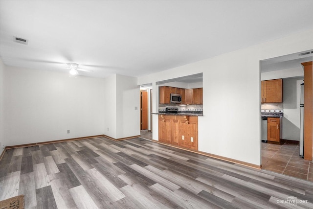 2301 Bicentennial Ave Unit 5, Crest Hill, IL 60403 - unfurnished living room featuring a ceiling fan and wood finished floors