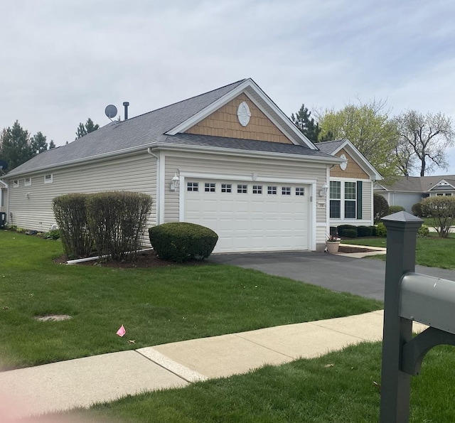 13065 Big Horn Dr, Huntley, IL 60142 - view of side of property with an attached garage, asphalt driveway, and a lawn