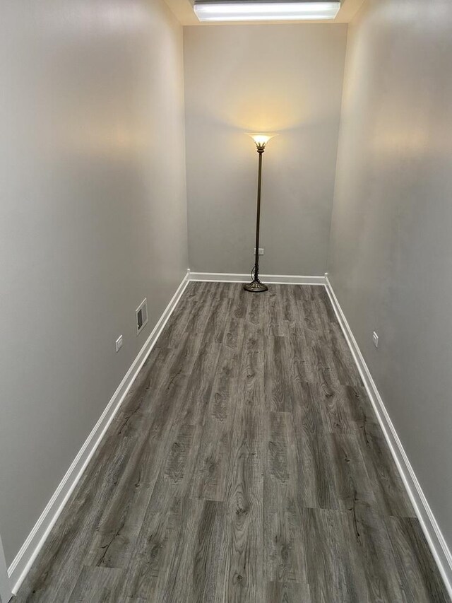 13065 Big Horn Dr, Huntley, IL 60142 - empty room featuring dark wood-type flooring and baseboards