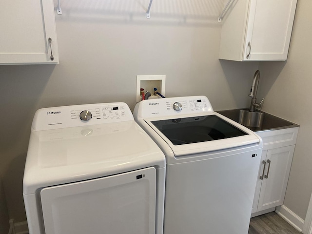 13065 Big Horn Dr, Huntley, IL 60142 - laundry area featuring cabinet space, washer and clothes dryer, and wood finished floors
