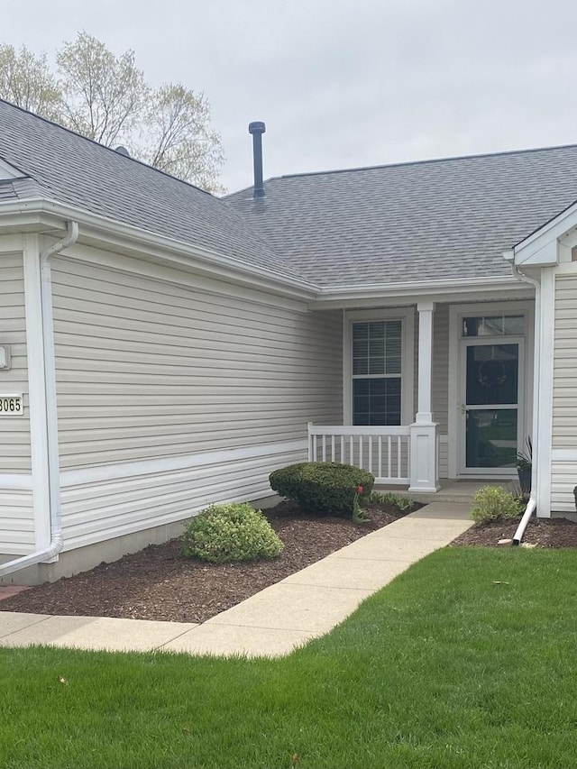 13065 Big Horn Dr, Huntley, IL 60142 - doorway to property with covered porch, roof with shingles, and a yard