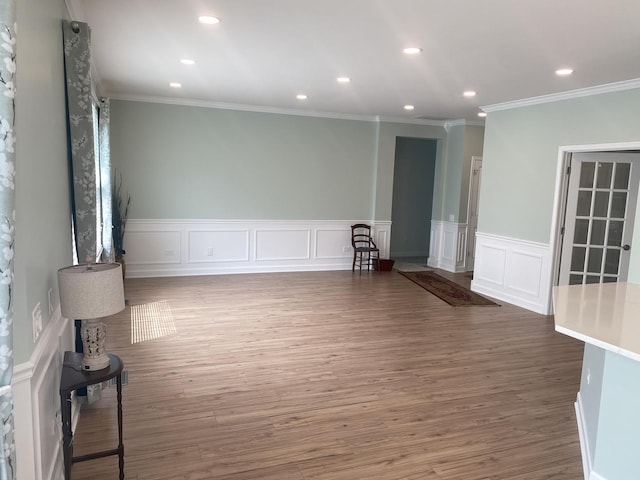 13065 Big Horn Dr, Huntley, IL 60142 - empty room featuring ornamental molding, wainscoting, wood finished floors, recessed lighting, and a decorative wall