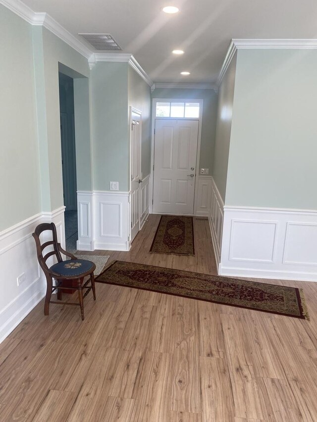 13065 Big Horn Dr, Huntley, IL 60142 - entryway with a decorative wall, ornamental molding, a wainscoted wall, and wood finished floors