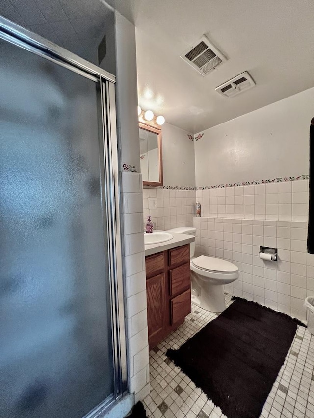 6631 W 89th Pl, Oak Lawn, IL 60453 - bathroom featuring tile patterned flooring, vanity, tile walls, a stall shower, and wainscoting