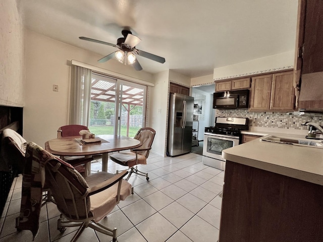 6631 W 89th Pl, Oak Lawn, IL 60453 - kitchen with stainless steel appliances, a ceiling fan, light countertops, decorative backsplash, and light tile patterned floors