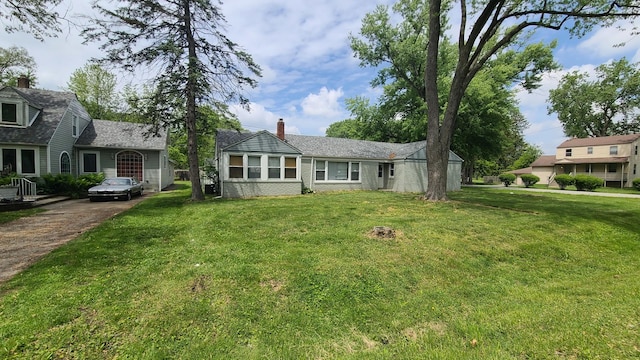 16002 Spaulding Ave, Markham, IL 60428 - view of front facade with a front lawn, a chimney, and driveway