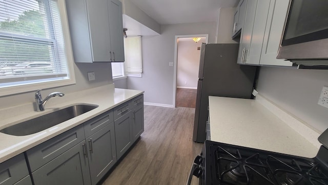 16002 Spaulding Ave, Markham, IL 60428 - kitchen with gray cabinets, appliances with stainless steel finishes, light countertops, and wood finished floors