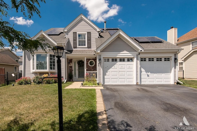40 Jackson Ln, Streamwood, IL 60107 - traditional-style house with an attached garage, driveway, solar panels, and a shingled roof